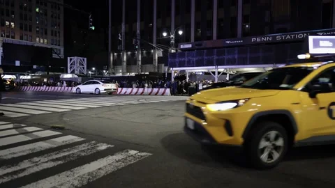 NYC yellow cab in front of Penn Station in Manhattan at night. Traffic in NYC Stock Footage 199347478