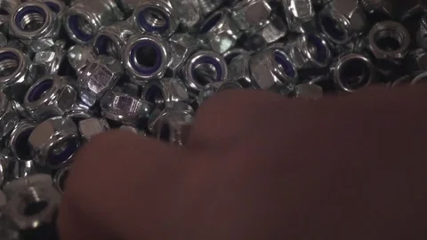 Nylon-Insert Nuts Being Gathered by a Shop Assistant Stock Footage 77024175