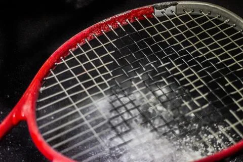 Nylon strings of a tennis racket on a background of white powder 스톡 사진