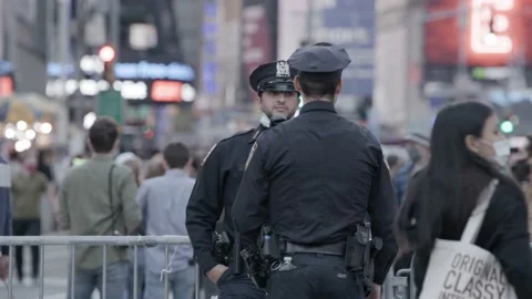 NYPD cop chatting in TSQ during 2020 Biden president election Stock Footage 142724124