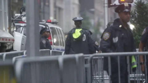 NYPD standing in heavy rain protecting T... | Stock Video | Pond5