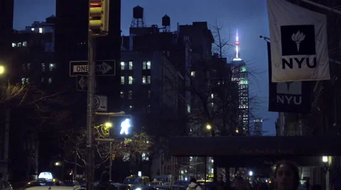NYU dorm Samuel Rubin with flags panning to 5th avenue taxicabs, taxi turning  Stock Footage 58873896