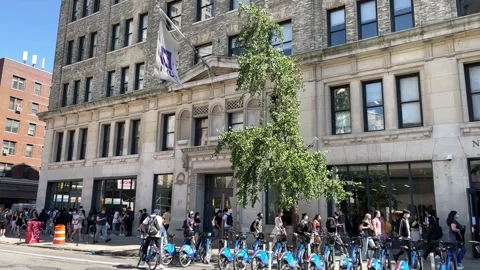 NYU students walking slow motion crowded street Citibikes parked New York City Stock Footage 160608277