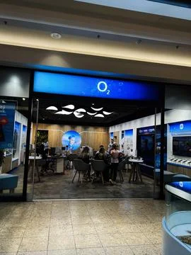 O2 store interior with customers and staff in a modern tech shop setting Stock Photos