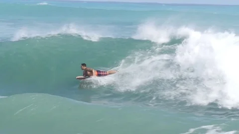 OAHU HAWAII - SEPT 5, 2016 Slow Motion people riding boogie board in Sandy Beach Stock Footage 74642301