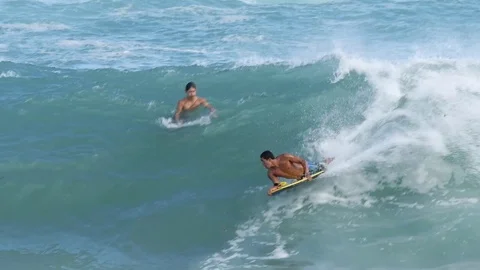 OAHU HAWAII - SEPT 5, 2016 Slow Motion people riding boogie board in Sandy Beach Stock Footage 74642314