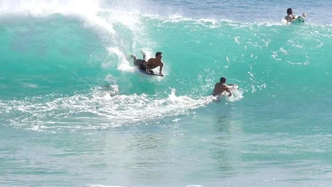 OAHU HAWAII - SEPT 5, 2016 Slow Motion people riding boogie board in Sandy Beach Stock Footage 74642347