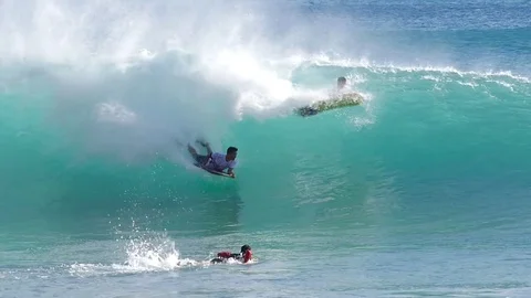 OAHU HAWAII - SEPT 5, 2016 Slow Motion people riding boogie board in Sandy Beach Stock Footage 74642368