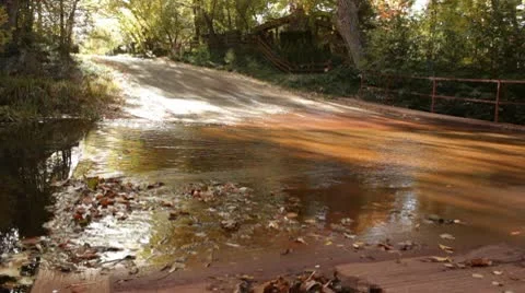 Oak Creek Flows Gently over Concrete Road Vídeo Stock 8955497