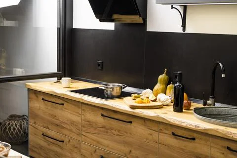 Oak kitchen worktop on kitchen with a sink, cookstove and food ingredients Stock Photos