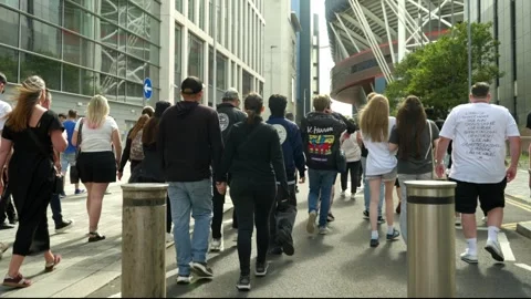 Oasis fans gather and wait to enter stadium for long awaited reunion concert Stock Footage 312470094