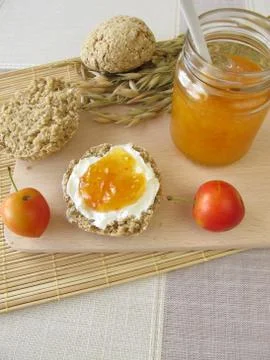 Oat bread roll with cherry plum jam Stock Photos