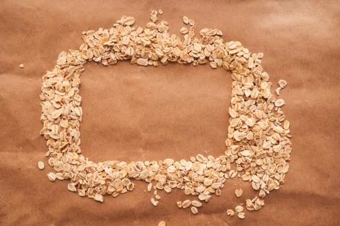Oat croup in the shape of rectangle lies on a brown background Stock Photos