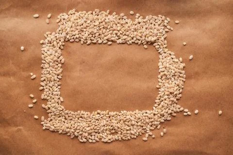 Oat croup in the shape rectangle lies on a cinnamon background Stock Photos