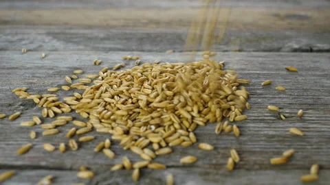Oat falling on a wooden table - slow motion Видео 155390433