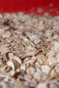 Oat flakes, background or texture of oat flakes close-up. A pile of dry oat f Stock Photos