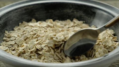 Oat flakes mixed with a spoon Stock Footage 143525829