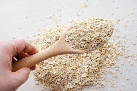 Oat flakes over white background Stock Photos