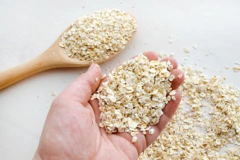 Oat flakes over white background Stock Photos