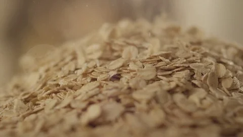 Oat flakes pile fall on glass RAPID 100fps Stock Footage 74655657