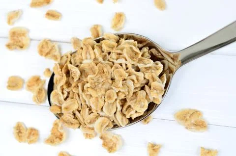 Oat flakes in silver spoon Stock Photos