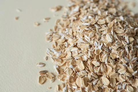 Oat flakes on a white background. Close-up. Healthy food. Stock Photos