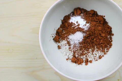 Oat flour with cocoa powder and sugar in a bowl on the wood, Top view Stock Photos