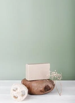 Oat milk organic solid soap bar on stone podium and natural reusable luffa fa Stock Photos