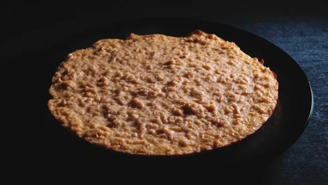 Oatmeal and lean cheese pie on a black plate Stock-Footage 166356231