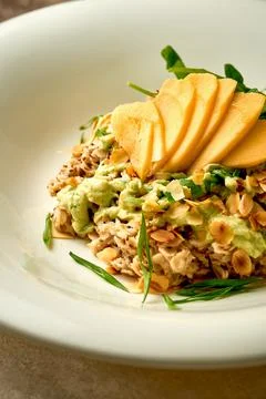 Oatmeal with avocado mousse and mango in a bowl. Selective focus, close-up Stock Photos