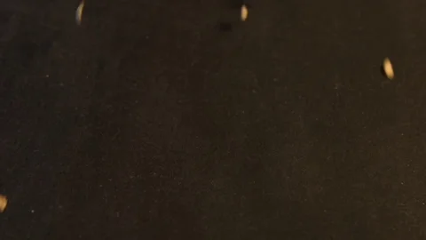 Oatmeal on a black background. Slow motion. Close-up. Видео 70045947