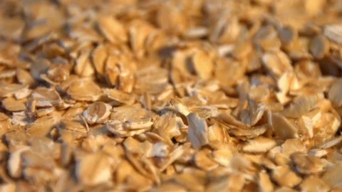 Oatmeal on a black background. Slow motion. Vertical pan. Close-up. Видео 70046710