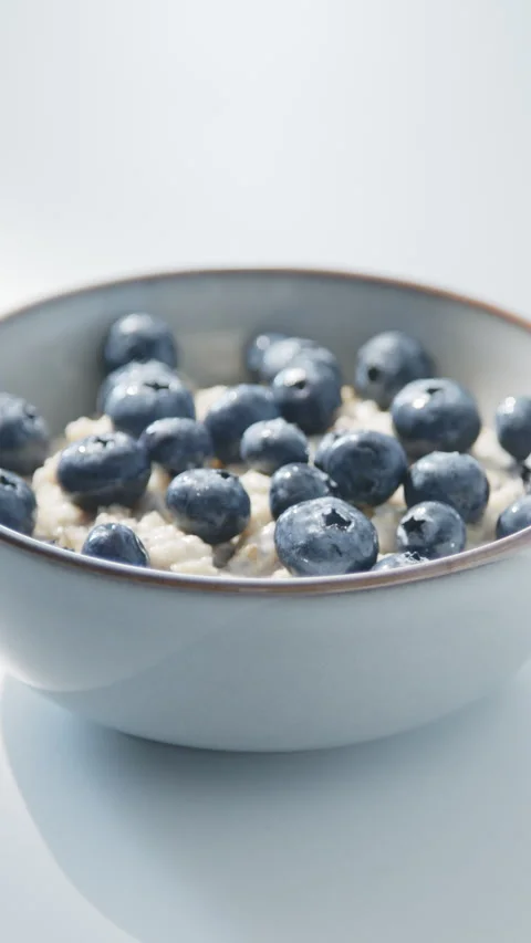 Oatmeal with Blueberries and Chia Seeds in Light Gray Bowl Stock Footage 337645853