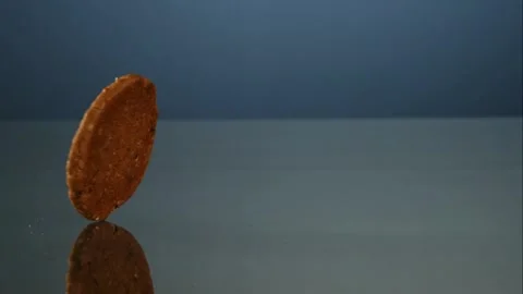 An oatmeal cookie rolls on a dark table Video stock 326748804