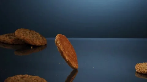 Oatmeal cookie rolls on a reflective surface Stock Footage 326754040