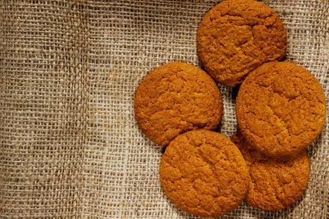Oatmeal cookie on sackcloth Stock Photos