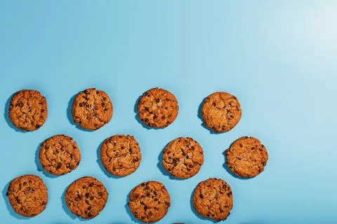 Oatmeal cookies with chocolate chip pattern and patterns on a light blue back Stock Photos