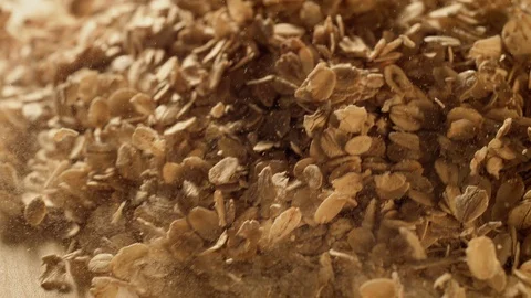 Oatmeal falling on a table. Slow Motion. Stock Footage 128952957