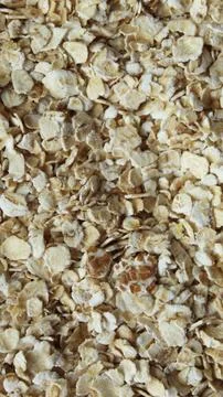 Oatmeal flakes vertical macro texture top view Stock Photos