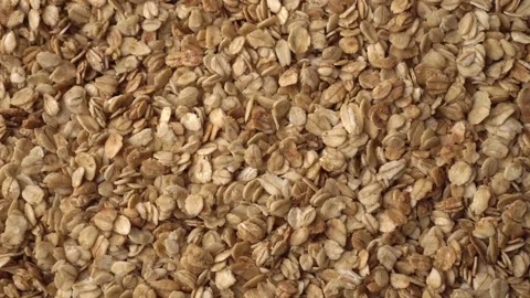 Oatmeal or crunchies form a slowly rotating textured background. Concept of Stock Footage 242524756