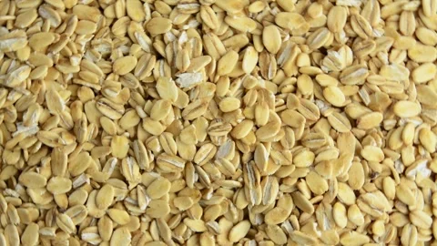 Oatmeal rotates, top view. Slow rotation. Raw rolled oats. Healthy breakfast. Stock Footage 290932766
