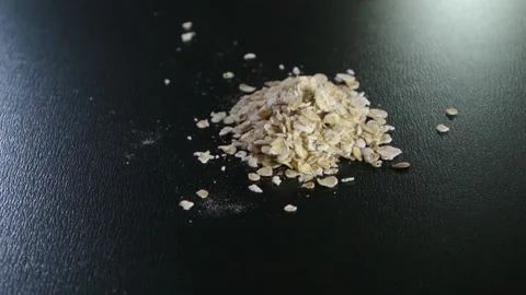 Oatmeal rotating on a black background closeup Stock Footage