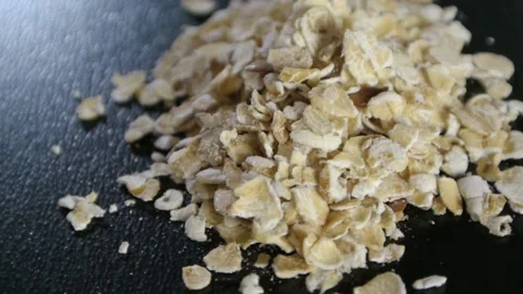 Oatmeal rotating on a black background macro Stock Footage 147946772