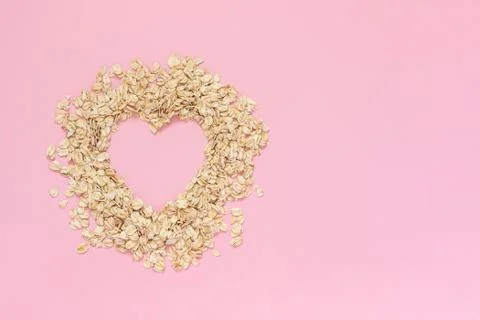 Oatmeal in shape of heart with empty space for text on pink background. Diet  Stock Photos