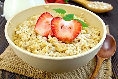 Oatmeal with strawberries on sacking Stock Photos