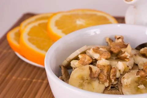 Oatmeal with walnuts and oranges Stock Photos