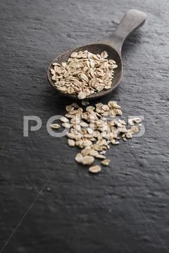 Oats On And Next To A Wooden Spoon