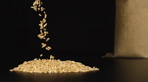An oats fall in a pile on a table near a bag Stock Footage 59021564