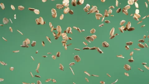 Oats falling in slow motion, green screen.  Shot with Phantom Flex 4K camera. Stock Footage 162863015