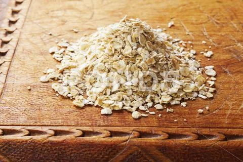 Oats on an old wooden board Stock Photos